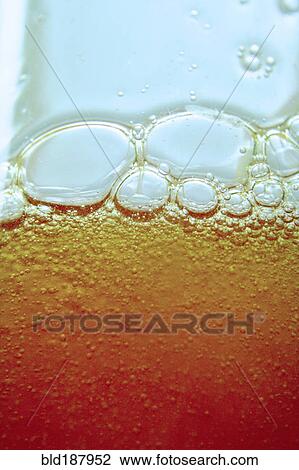 Close up of bubbles in beer glass View Large Photo Image Stock Image - Close up of bubbles in beer glass. Fotosearch