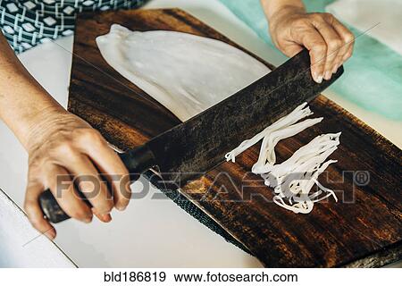 Close up of chef chopping squid on cutting board View Large Photo Image Stock Photo - Close up of chef chopping squid on cutting board. Fotosearch