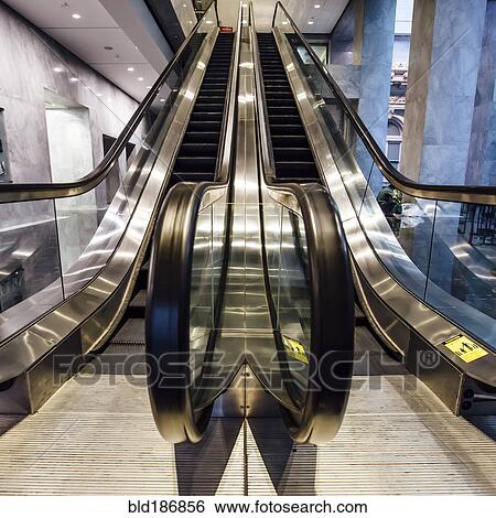 Stock Photograph - Close up of escalator handrail in office building. Fotosearch