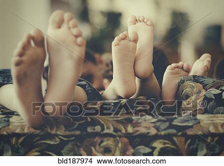 Close up of feet of children on sofa View Large Photo Image Picture - Close up of feet of children on sofa. Fotosearch