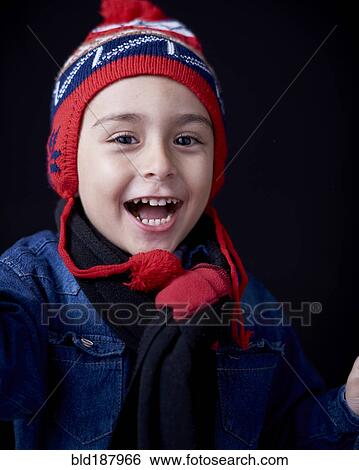Stock Photograph - Close up of Hispanic boy wearing warm clothing. Fotosearch