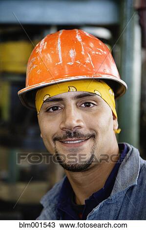 Close up of Hispanic man wearing hard hat View Large Photo Image Stock Image - Close up of Hispanic man wearing hard hat. Fotosearch