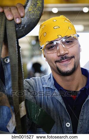 Stock Photo - Close up of Hispanic man wearing protective eyewear. Fotosearch