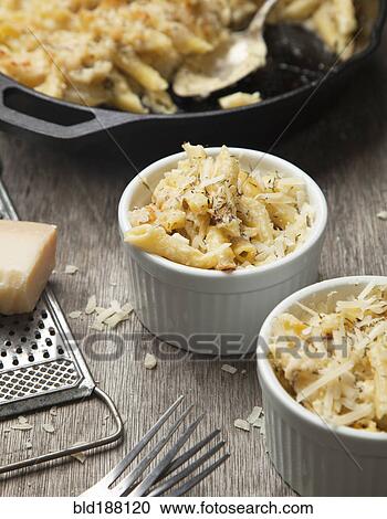 Stock Image - Close up of macaroni and cheese ramekins. Fotosearch