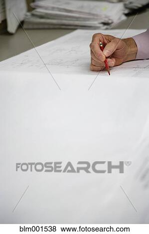 Close up of man's hand writing on blueprints View Large Photo Image Stock Photo - Close up of man's hand writing on blueprints. Fotosearch