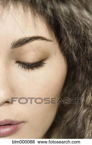Close up of Mixed Race woman with eyes closed View Large Photo Image Stock Photo - Close up of Mixed Race woman with eyes closed. Fotosearch