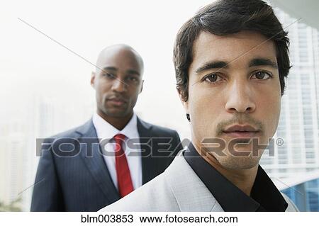 Stock Image - Close up of serious businessmen. Fotosearch