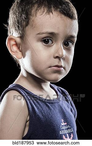 Stock Image - Close up of serious Hispanic boy. Fotosearch