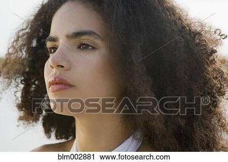 Stock Image - Close up of serious Hispanic woman. Fotosearch