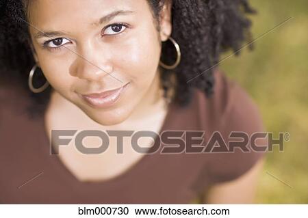 Stock Image - Close up of smiling mixed race woman. Fotosearch