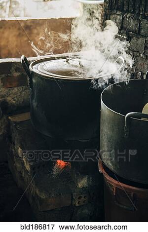 Close up of steamy pot cooking on stove View Large Photo Image Stock Photo - Close up of steamy pot cooking on stove. Fotosearch