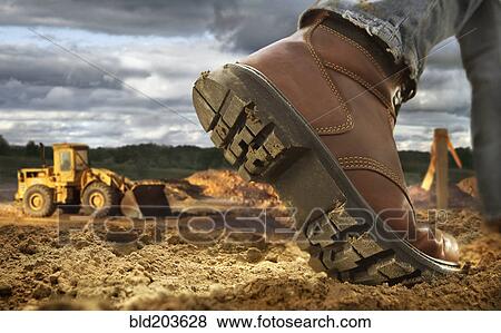 Stock Photo - Close up of worker's boot on construction site. Fotosearch