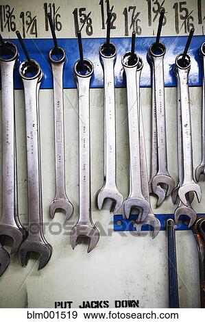 Stock Photo - Close up of wrenches hanging on wall. Fotosearch