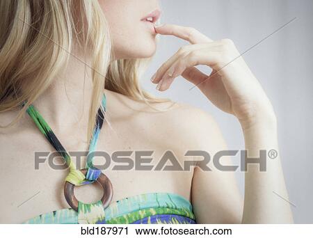 Close up profile of woman touching her lips View Large Photo Image Stock Image - Close up profile of woman touching her lips. Fotosearch