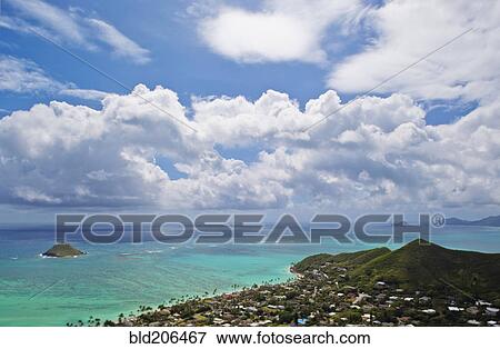 Stock Photo - Clouds in blue sky over islands, Hawaii, United States. Fotosearch