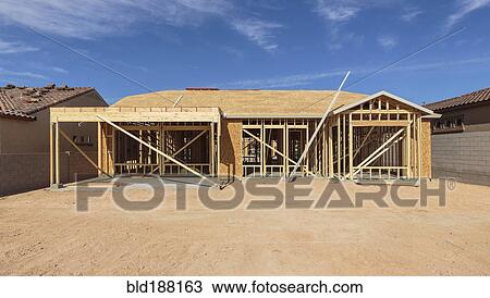 Stock Image - Construction of house under blue sky. Fotosearch