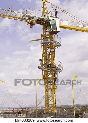 Stock Photo - Construction worker on top of crane. Fotosearch