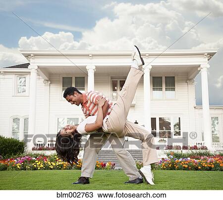 Couple dancing in front of luxury home View Large Photo Image Stock Image - Couple dancing in front of luxury home. Fotosearch