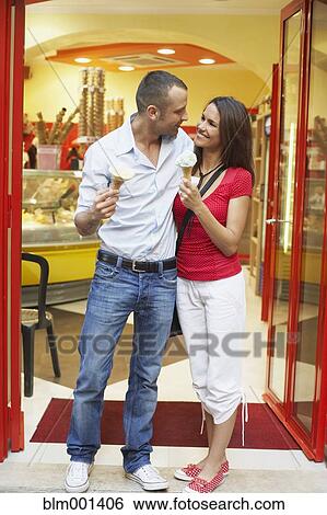 Couple eating ice cream cones View Large Photo Image Stock Photograph - Couple eating ice cream cones. Fotosearch