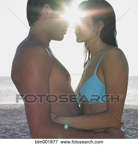 Couple hugging at beach View Large Photo Image Stock Photo - Couple hugging at beach. Fotosearch