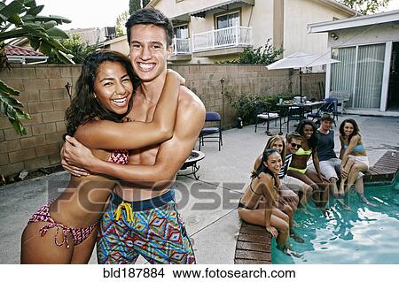 Picture - Couple hugging near swimming pool. Fotosearch
