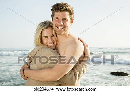 Picture - Couple hugging on beach. Fotosearch