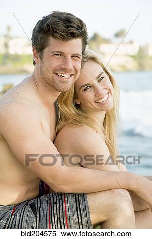 Stock Photography - Couple hugging on beach. Fotosearch