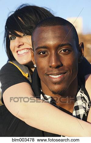Stock Photo - Couple hugging outdoors. Fotosearch