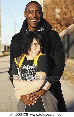 Stock Photograph - Couple hugging outdoors. Fotosearch