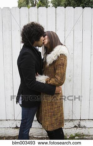 Stock Image - Couple in retro clothing kissing. Fotosearch