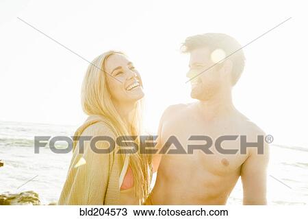 Couple laughing on beach View Large Photo Image Stock Image - Couple laughing on beach. Fotosearch