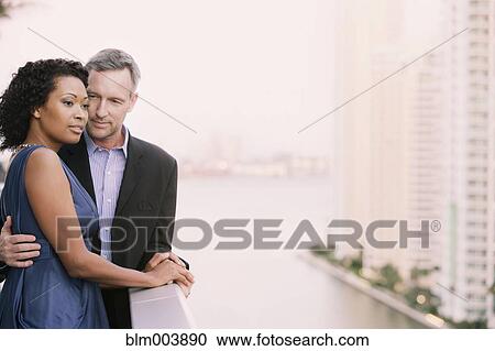 Stock Image - Couple on urban balcony. Fotosearch