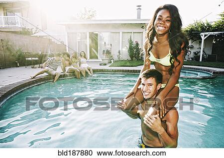 Couple playing in swimming pool View Large Photo Image Stock Image - Couple playing in swimming pool. Fotosearch