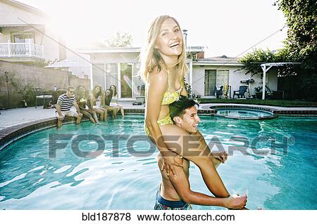 Stock Photo - Couple playing in swimming pool. Fotosearch
