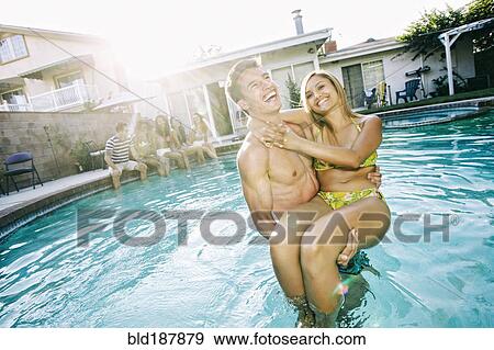 Couple playing in swimming pool View Large Photo Image Stock Photo - Couple playing in swimming pool. Fotosearch