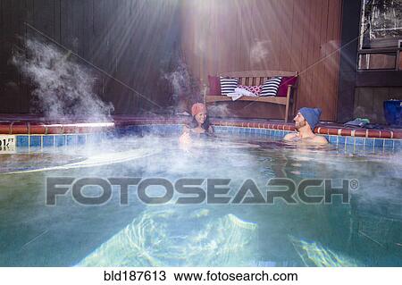 Stock Image - Couple relaxing in hot tub. Fotosearch
