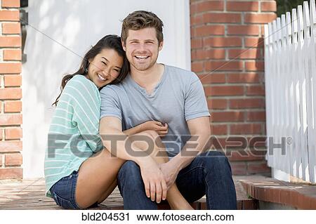 Stock Image - Couple smiling together outdoors. Fotosearch