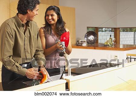 Picture - Couple washing dishes in kitchen. Fotosearch
