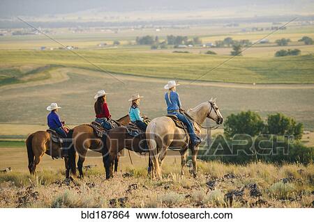 Cowboy and cowgirls on horseback admiring rural landscape View Large Photo Image Picture - Cowboy and cowgirls on horseback admiring rural landscape. Fotosearch