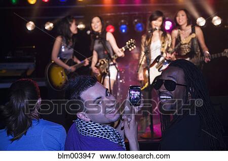 Stock Photo - Crowd watching musical group perform. Fotosearch