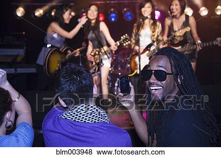 Stock Photo - Crowd watching musical group perform. Fotosearch