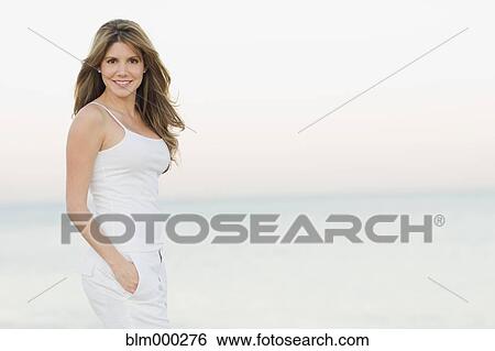 Stock Photograph - Cuban woman smiling at beach. Fotosearch
