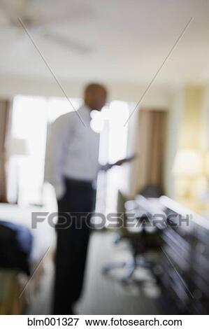 Stock Photo - Defocused African businessman in hotel. Fotosearch