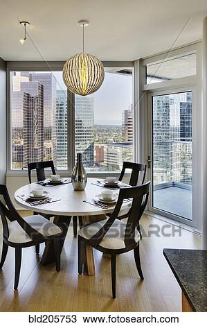 Stock Image - Dining room in luxury highrise apartment. Fotosearch