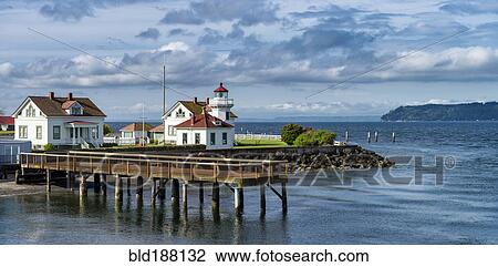 Stock Image - Dock and buildings on scenic coastline. Fotosearch