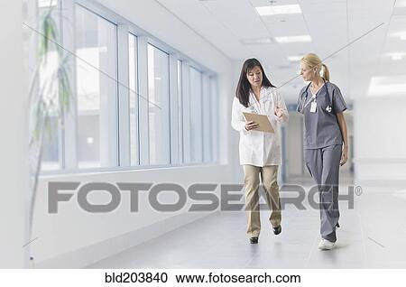 Doctor and nurse talking in hospital View Large Photo Image Stock Image - Doctor and nurse talking in hospital. Fotosearch