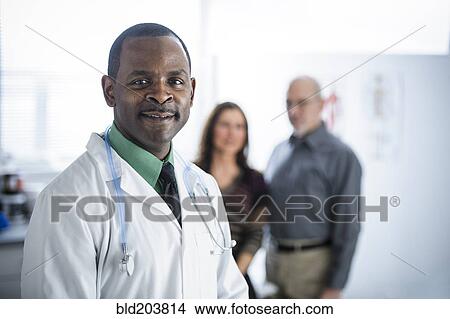 Picture - Doctor and patients standing in office. Fotosearch