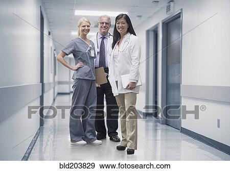 Doctors and nurse smiling in hospital View Large Photo Image Stock Photo - Doctors and nurse smiling in hospital. Fotosearch
