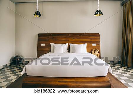 Stock Image - Empty bed in modern hotel room. Fotosearch