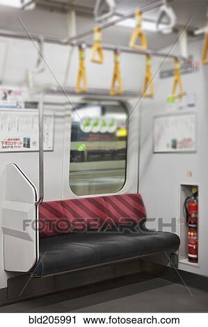Stock Image - Empty seat on subway train, Tokyo, Japan. Fotosearch